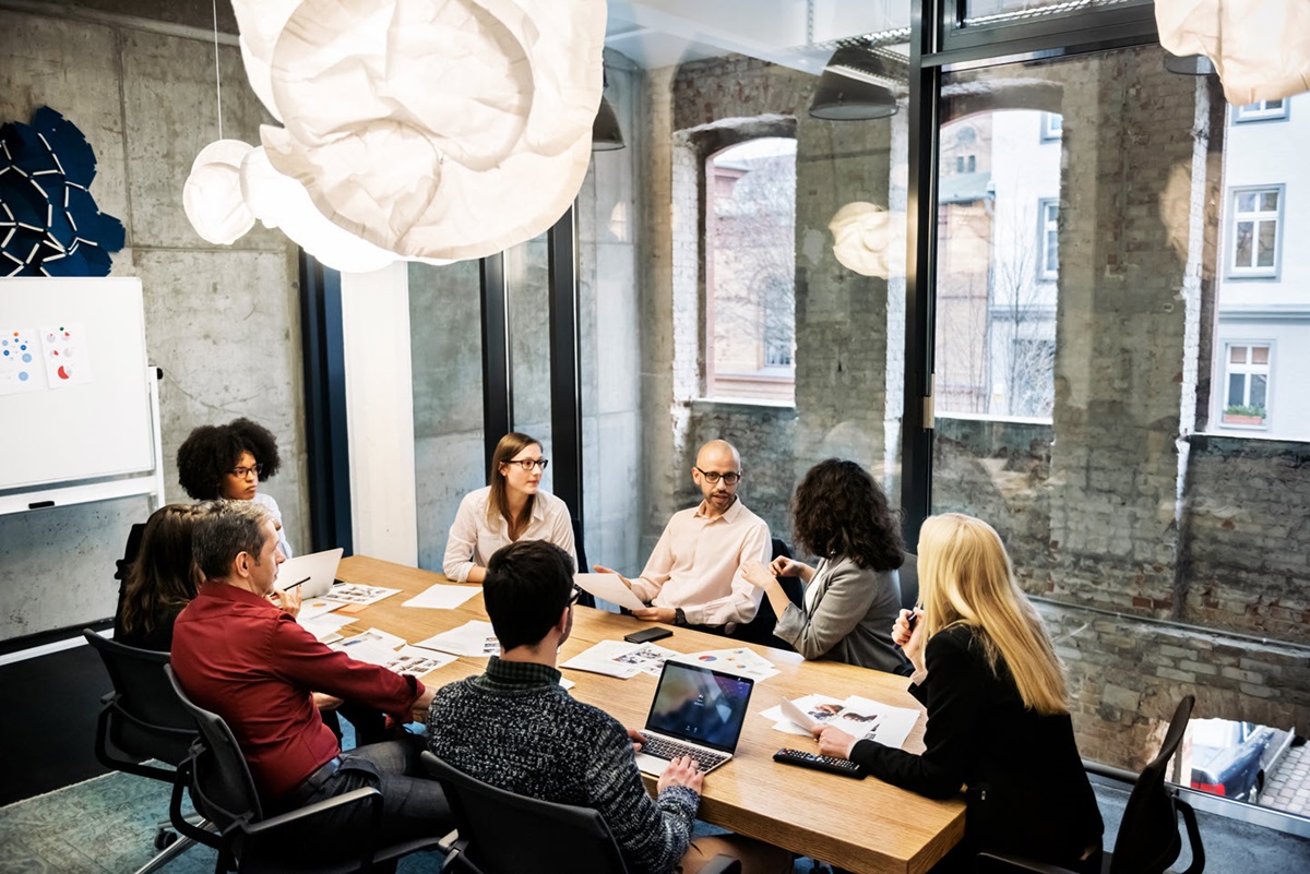 A group of office workers having a meeting inside a conference room.