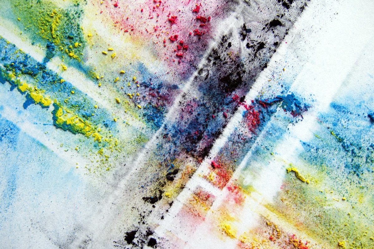 Streaks and speckles of multicolored printer toner make an abstract, vibrant image.