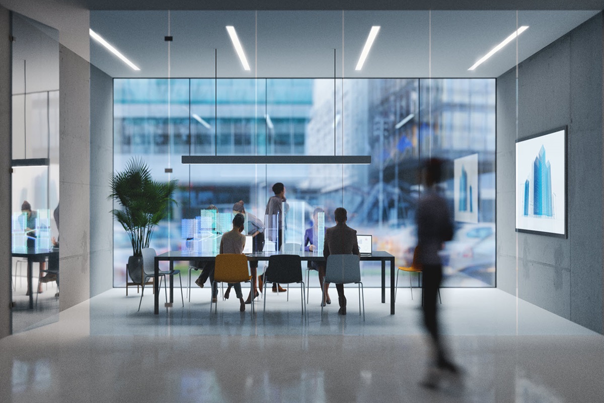 A group of people working in a high-tech office boardroom.
