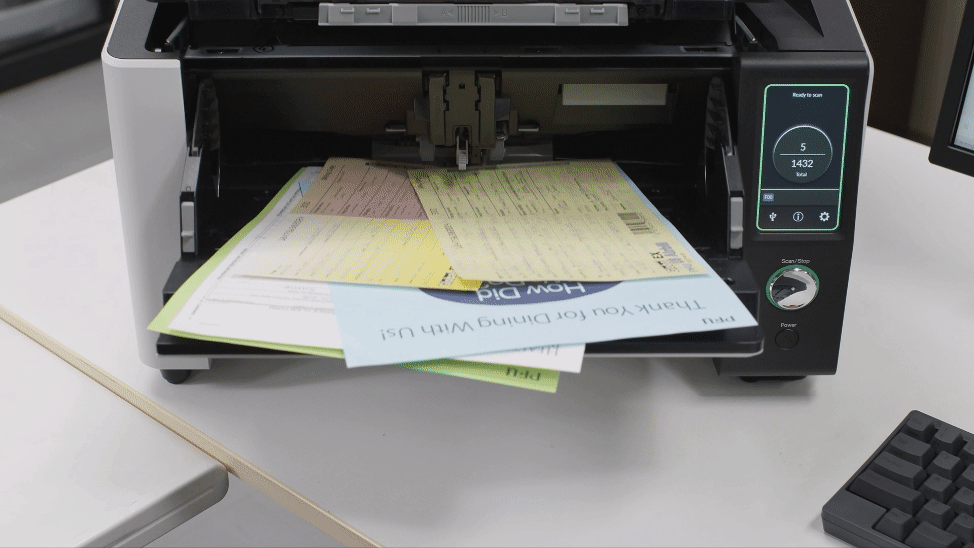 The Ricoh fi-8950 production scanner scanning and straightening skewed documents in the automatic document feeder. 