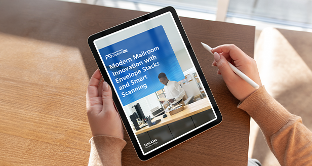 Hands holding a tablet and a pen looking at a white paper on the screen.