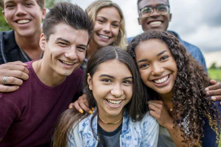 Group of youth smiling outside