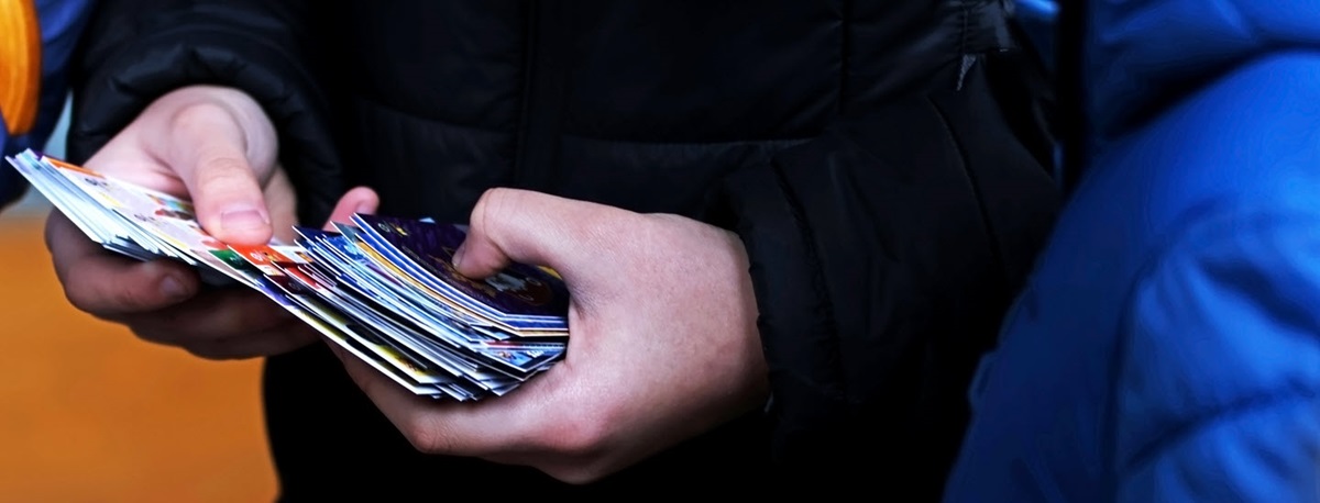 Person holding game trading cards in hands. 