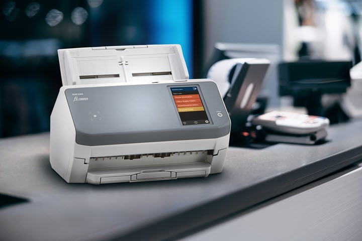 The Ricoh fi-7300NX sitting on a shop counter.