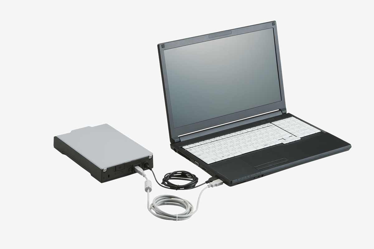 The compact fi-70F scanner plugged into a laptop. 