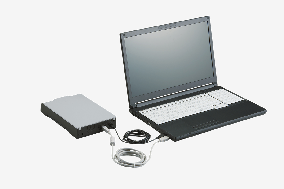 The compact fi-70F scanner plugged into a laptop.