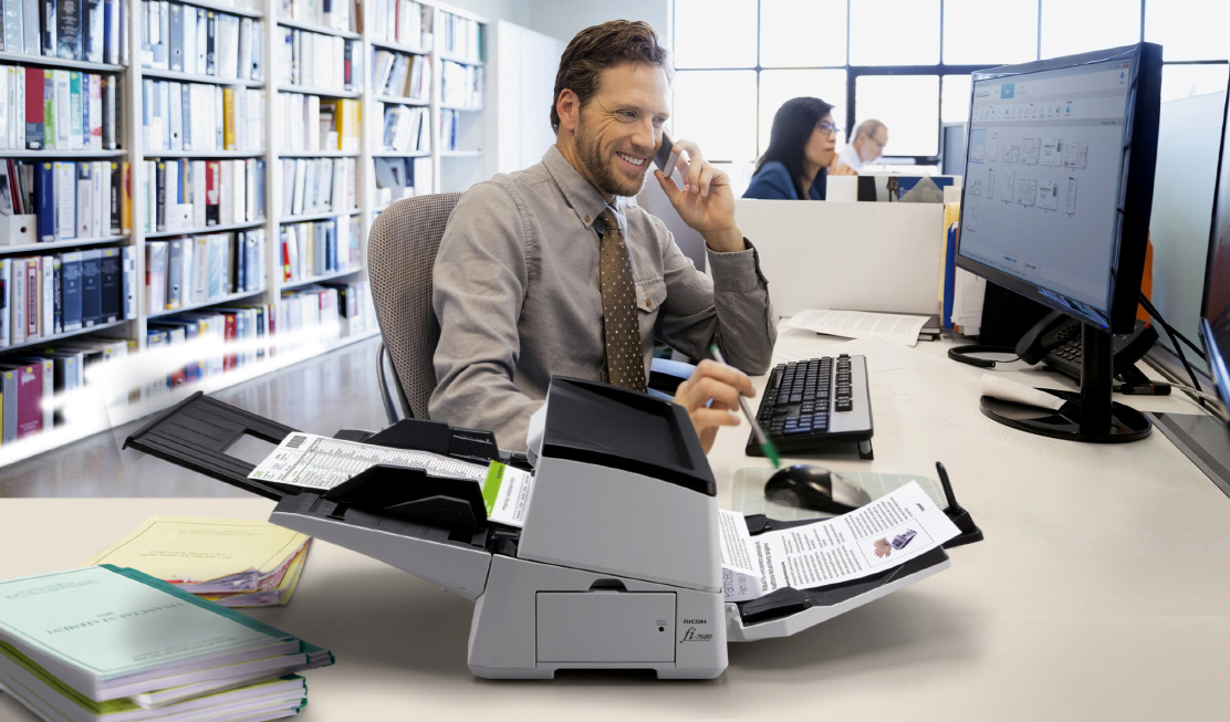 Businessman with the fi-7600 document scanner and using PaperStream software.