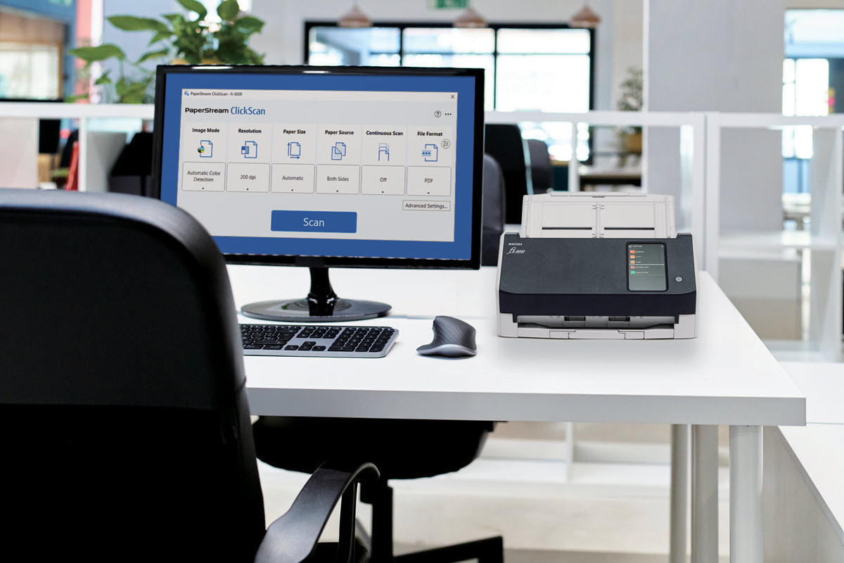 Desk with monitor with PaperStream Sofwre user interface and fi-8040 scanner. 