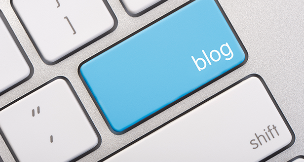 Close up image of keyboard with a blue key with the word "Blog."